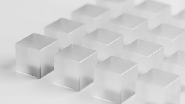 A minimalist arrangement of translucent glass cubes in a monochrome white setting. The cubes are neatly aligned in rows, showcasing geometric shapes, smooth textures, and soft reflections, creating a clean, abstract, and modern aesthetic.