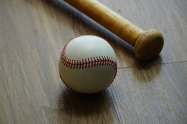 A wooden bat and a baseball are essential tools for every player on the field.