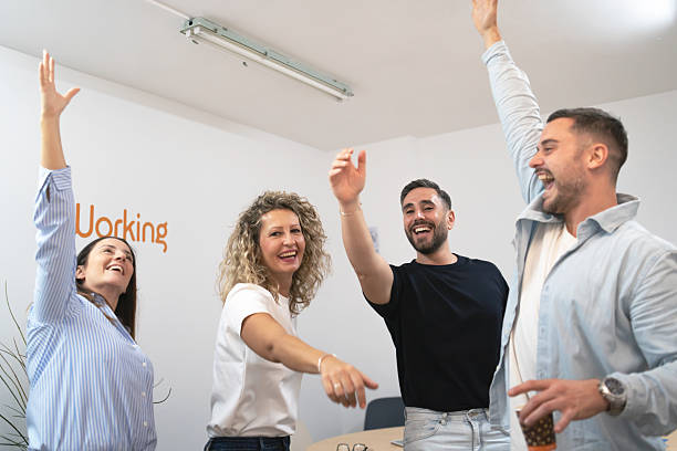 Diverse colleagues celebrating success and achievement in office