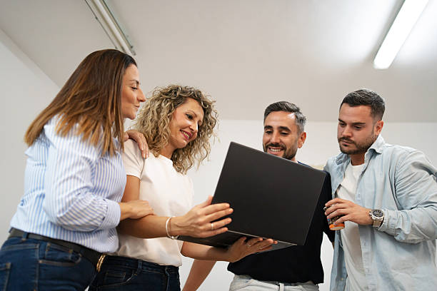 Business team collaborating on laptop, discussing new project