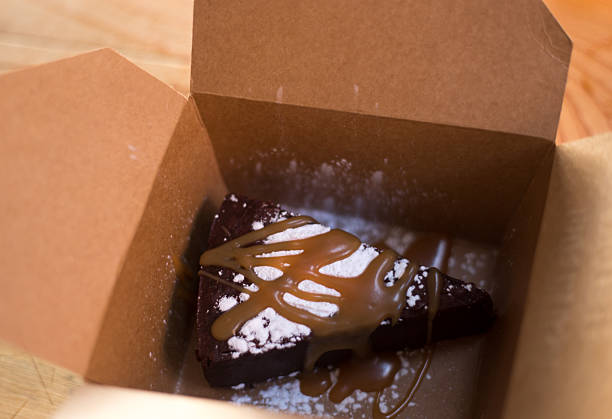 Chocolate Cake, Carmel Sauce Topping in Cardboard Take-Out Box