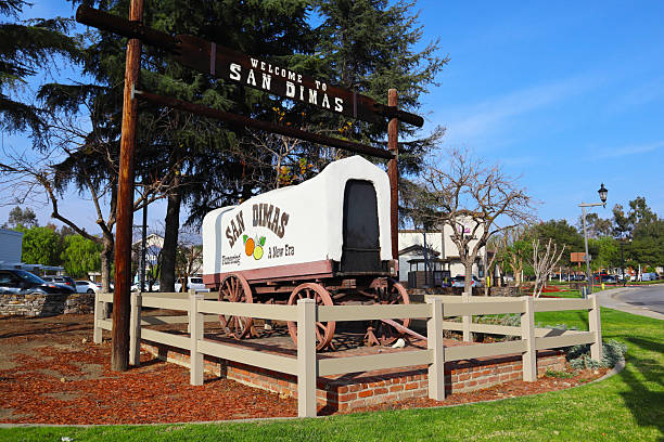 San Dimas, California – February 1, 2025: Welcome to San Dimas Sign with Covered Wagon located at the corner of Arrow Highway and Bonita Avenue