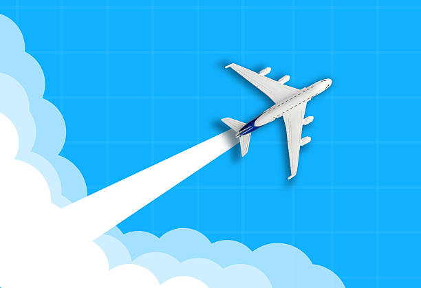 White toy airplane gliding across a bright blue sky with fluffy clouds, evoking freedom, travel, and adventure