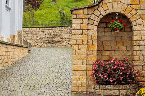 cell element street decorative object with flower pot in cobble stone street tile and old brick walls historical district landmark environment