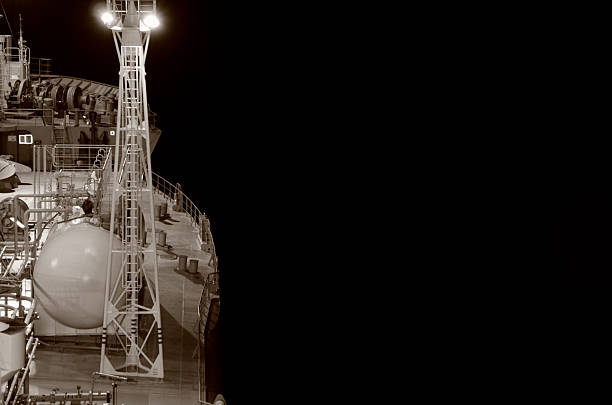 Part of gas tanker deck with deep black background of the sea (B&W)