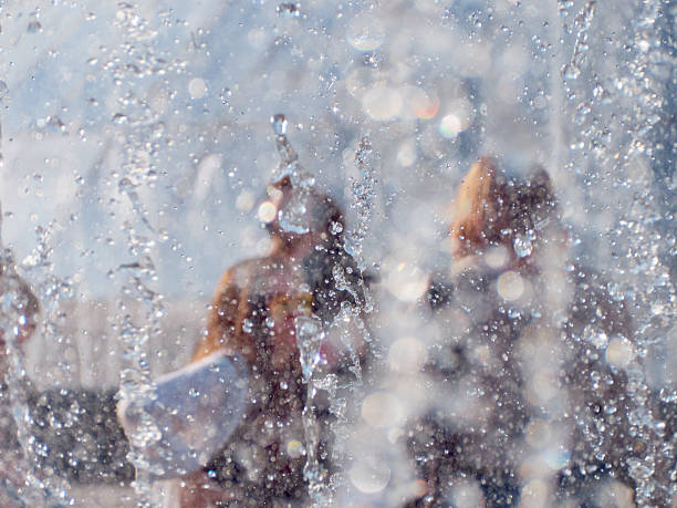 Children playing in a water fountain.