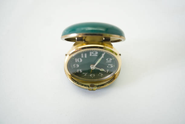 Classic gold-colored watch with green clamshell case