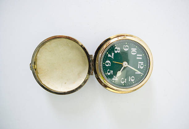 Classic gold-colored watch with green clamshell case