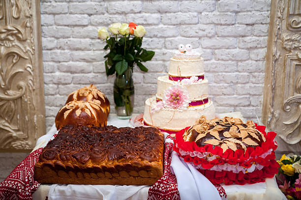 Tasty cakes and pastries!. A table displays various baked goods and a decorative cake, set in a festive atmosphere adorned with fresh flowers.