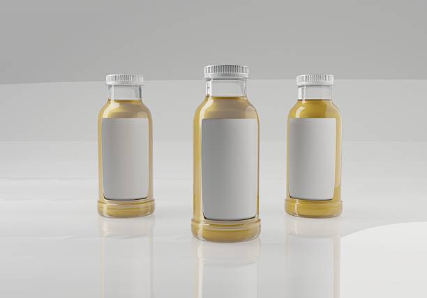 Three identical clear glass bottles with white caps and blank labels, filled with a golden liquid, are neatly arranged on a reflective white surface against a clean background.