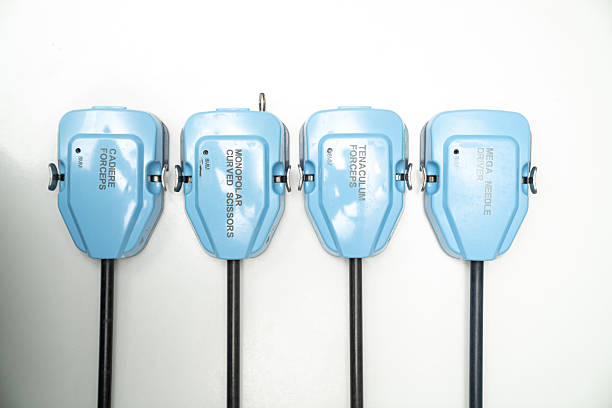 Collection of four surgical instruments on a white surface. Four distinct surgical instruments are neatly displayed on a white background, highlighting their unique designs.