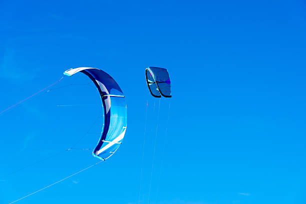 Multi colored kite flying in the blue sky with beautiful sunbeams. Space for copy.