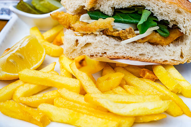 french fries and sandwich on a plate, selective focus