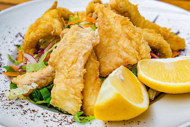 A plate of food with a yellow lemon and green peas, health meal