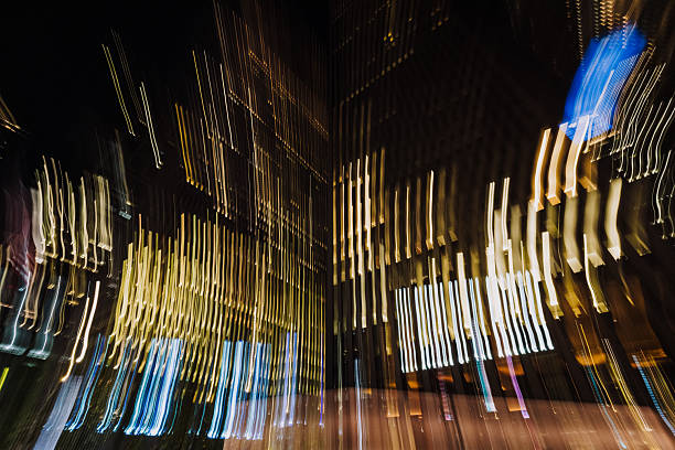 Abstract long exposure capture of bright light trails and glowing rectangles creating an artistic motion blur effect in a dark urban environment in New York City
