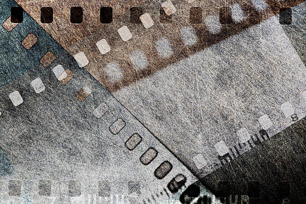 Tight close up of grey grunge scratched film strip background.