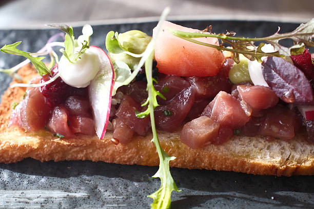 Fresh tuna tataki lightly seared on the outside and raw in the center, sliced and elegantly plated. This Japanese-inspired dish highlights texture, color contrast, and refined presentation. Ideal for themes like Asian cuisine, gourmet seafood, and healthy eating.