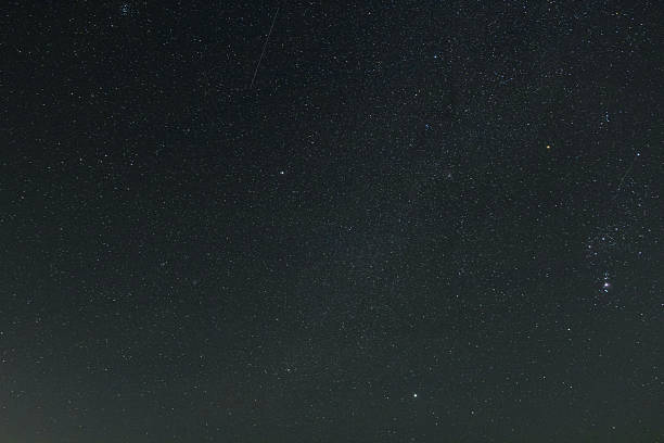 Bright stars illuminating the dark night sky, revealing a vast universe and the grandeur of the Orion constellation, evoking a sense of wonder and astronomical exploration
