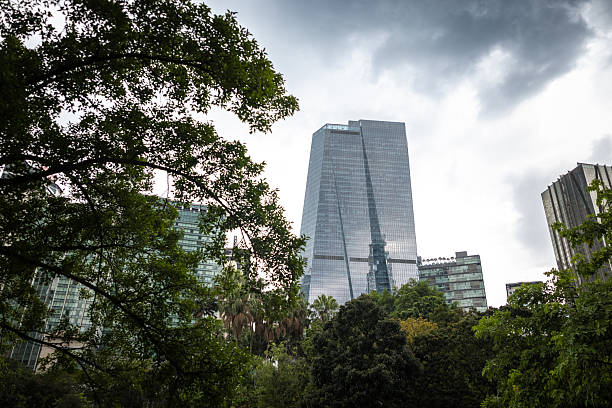 Skyscrapers, green buildings with cloudy blue sky background.KL - Malaysia.