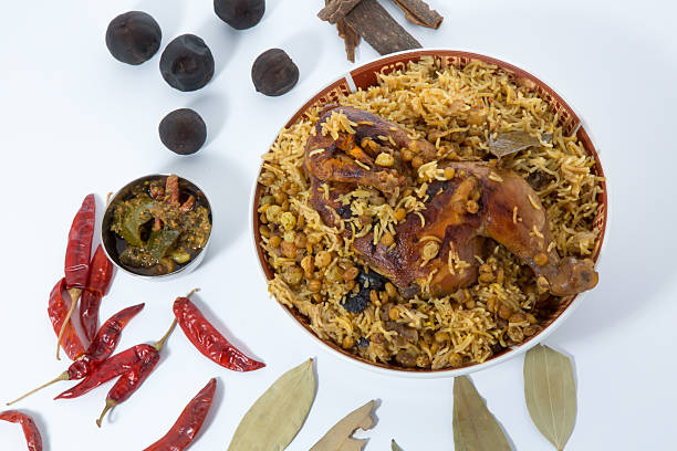 Delicious traditional Middle Eastern Chicken Machboos or Chicken Biryani with spices and herbs top view