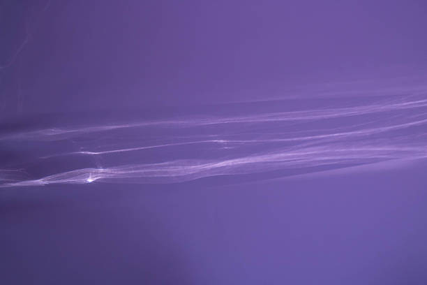 A lilac abstract background with sunlight glaring through the glass