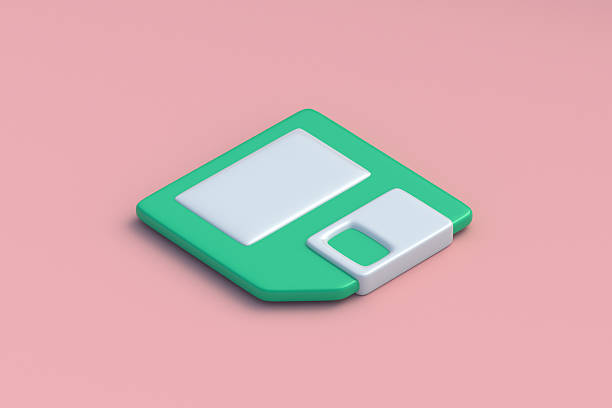 Generic HD floppy disks standing on floppy disk drive. Retro computer and data archive technology concept.