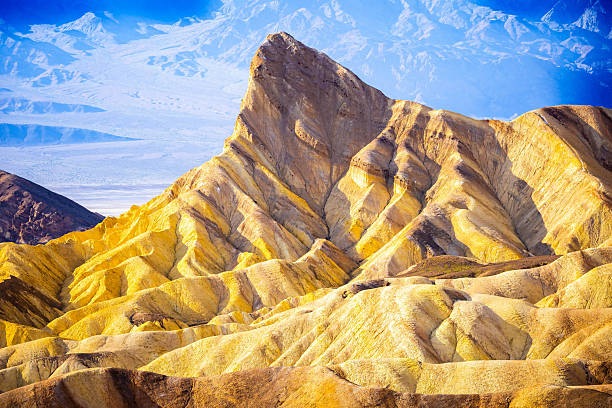 Panoramic sunny day view of colorful wavy badlands at Zabriskie Point Death Valley California