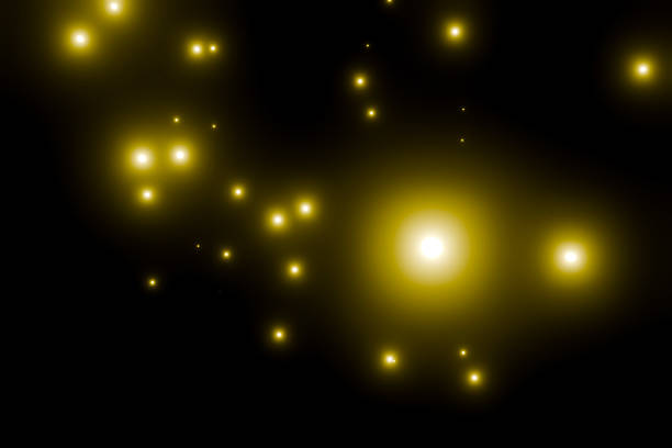 Many yellow particles floating on a black background