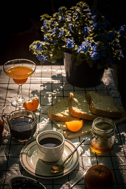 Top View of Breakfast Table with Coffee and Fruit in Natural Sunlight.