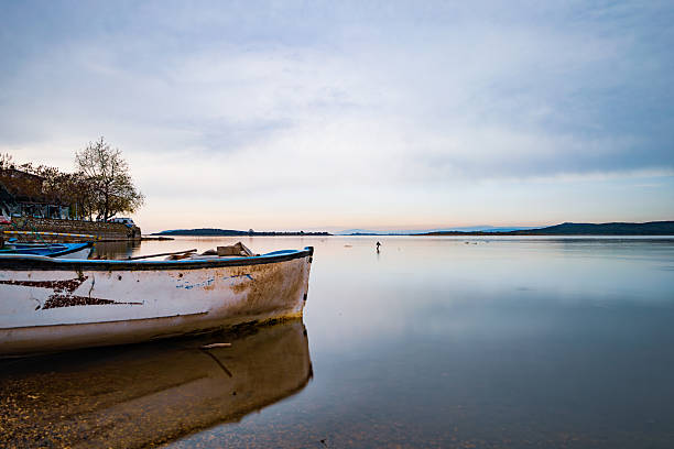 Sailing boat mooring, buoys and bateas in the background, Ría de Arousa,  Pontevedra province, Rías Baixas, Galicia, Spain.