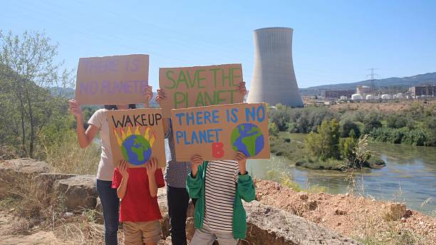 Portrait of child girl holding a sign about the environment on the protest