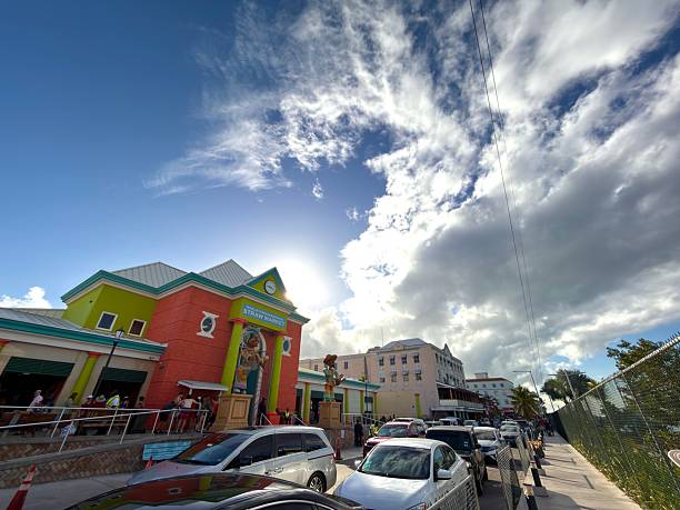 Nassau, Bahamas - January 7, 2026: Colorful Straw Market building in downtown Nassau, Bahamas, featuring vibrant architecture, traditional crafts, and local culture under a dynamic sky with traffic along Woodes Rogers Walk