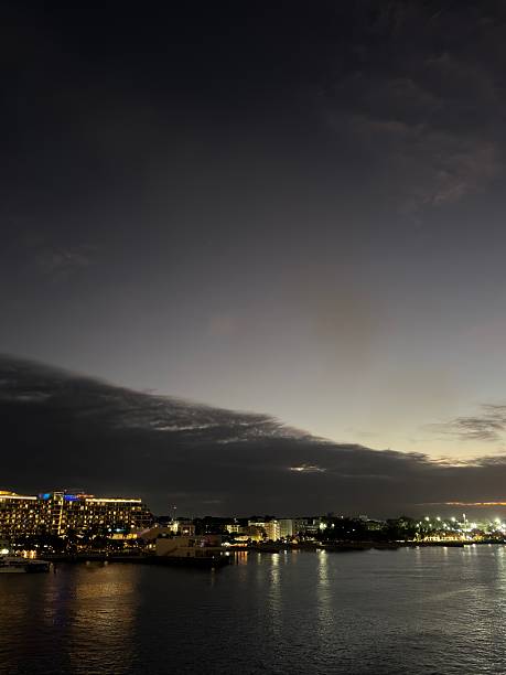 Nassau, Bahamas - January 7, 2026: Nassau cityscape at twilight, featuring city lights reflecting on the calm harbor water under a cloudy sky, showcasing a popular travel destination and scenic landscape