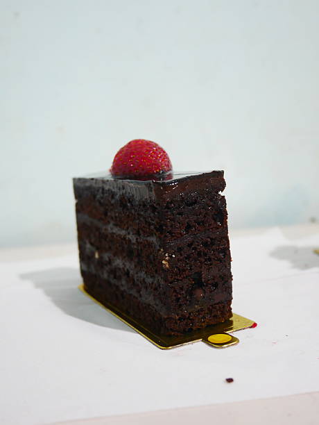 Decadent Chocolate Cake Slice with Glossy Ganache and Fresh Strawberry