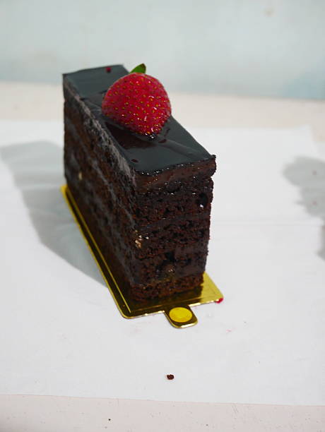 Decadent Chocolate Cake Slice with Glossy Ganache and Fresh Strawberry