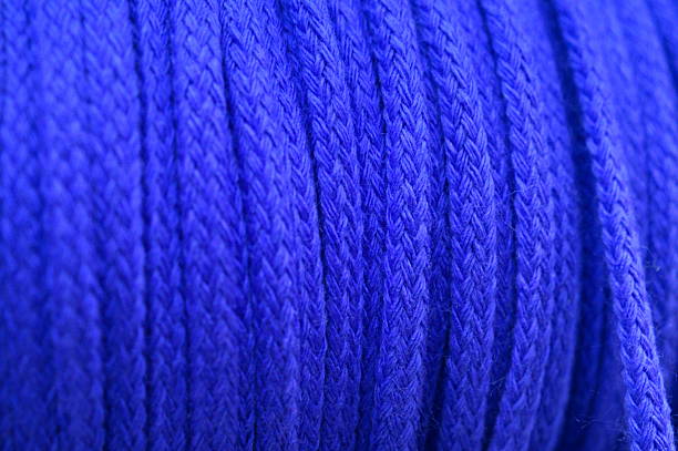 Close-up of various multicolored nylon ropes and braided cords displayed in a retail store.