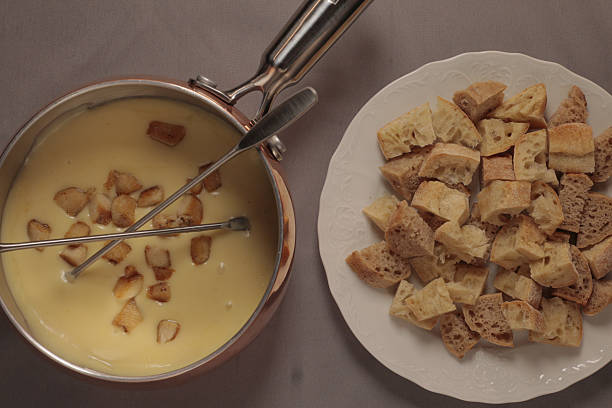 Swiss fondue made of white wine, dipping slices of Japanese beef stake and French bread.