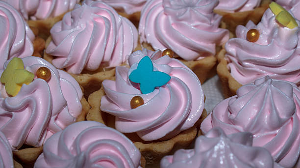 Assorted pink cupcakes with butterfly decorations
