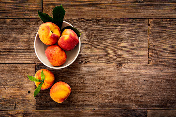 This is a photograph of Peaches on Retro wood Picnic Bench