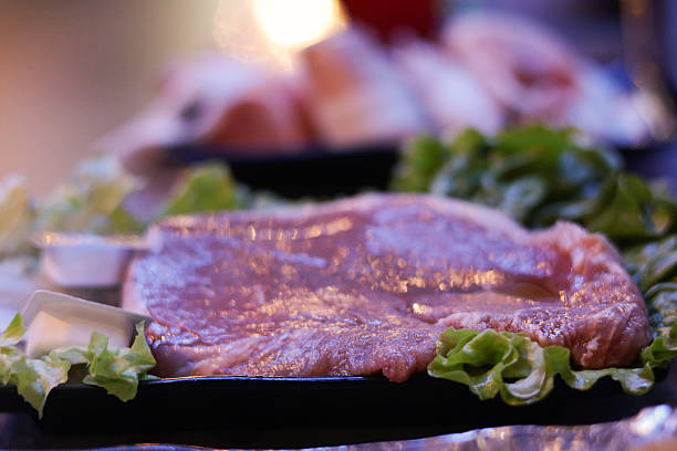 close-up of two filet mignon with rosemary and garlic