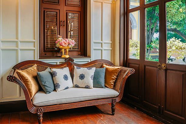 elegant vintage sofa placed in a refined neo-colonial style interior with wooden shutters, paneled walls, and warm natural light. The scene conveys heritage luxury, comfort, and timeless interior design, ideal for boutique hotels and upscale hospitality settings.