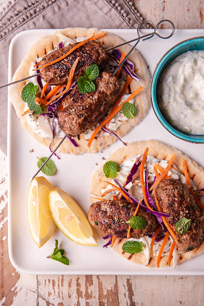 Grilled Lamb Kofta Skewers on Pita With Tzatziki, Lemon and Fresh Mint - Mediterranean Street Food