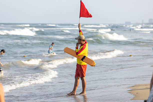 13 February 2026, Da Nang - Vietnam.A lifeguard monitors the shoreline as strong waves reach the beach. Da Nang’s coastline along the South China Sea can experience rough sea conditions, particularly during monsoon seasons. Lifeguards help ensure swimmer safety at popular beaches such as My An and My Khe.
