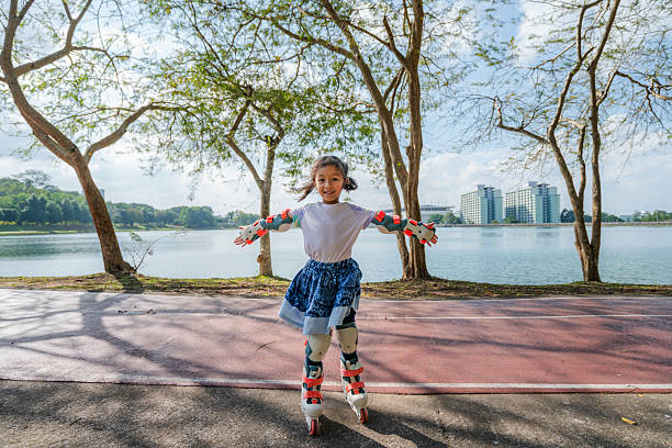 Asian girl skating with a smile. Active and fun lifestyle.
