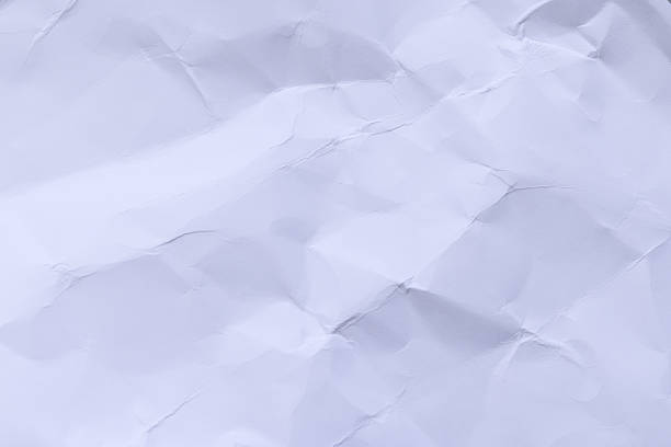 High-resolution macro shot of crumpled and wrinkled white paper. The texture features intricate folds, creases, and shadows, creating a tactile and organic feel. Perfect for background design, stationery mockups, recycling concepts, or creative overlays.