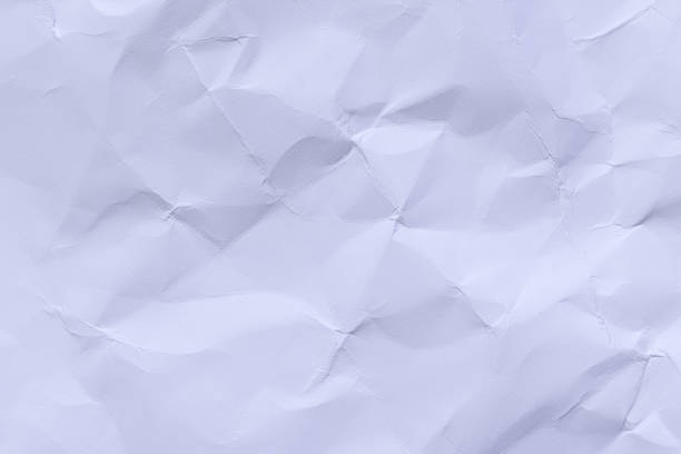 High-resolution macro shot of crumpled and wrinkled white paper. The texture features intricate folds, creases, and shadows, creating a tactile and organic feel. Perfect for background design, stationery mockups, recycling concepts, or creative overlays.