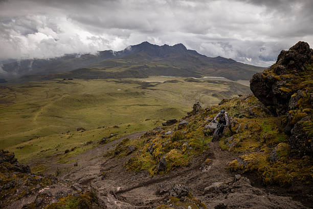 Male mountain biker rides down volcano, Cotopaxi National Park, Ecuadorian Andes