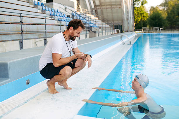 Teacher talking to kids in the swimming pool