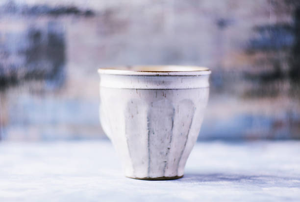 Close-up of a woman holding a mug at ceramics workshop