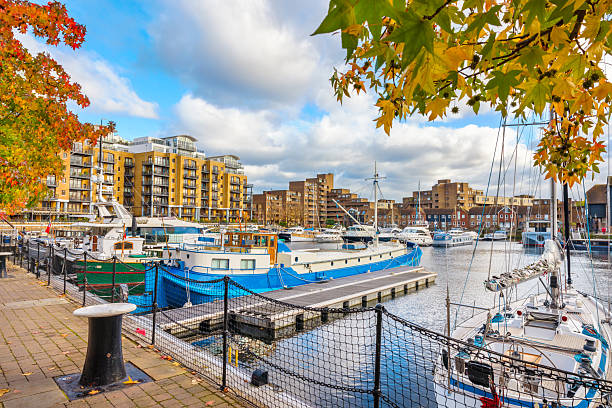 LONDON, UK - SEPTEMBER 24, 2019: St Katharine Docks with moored yachts and residential buildings in London, UK